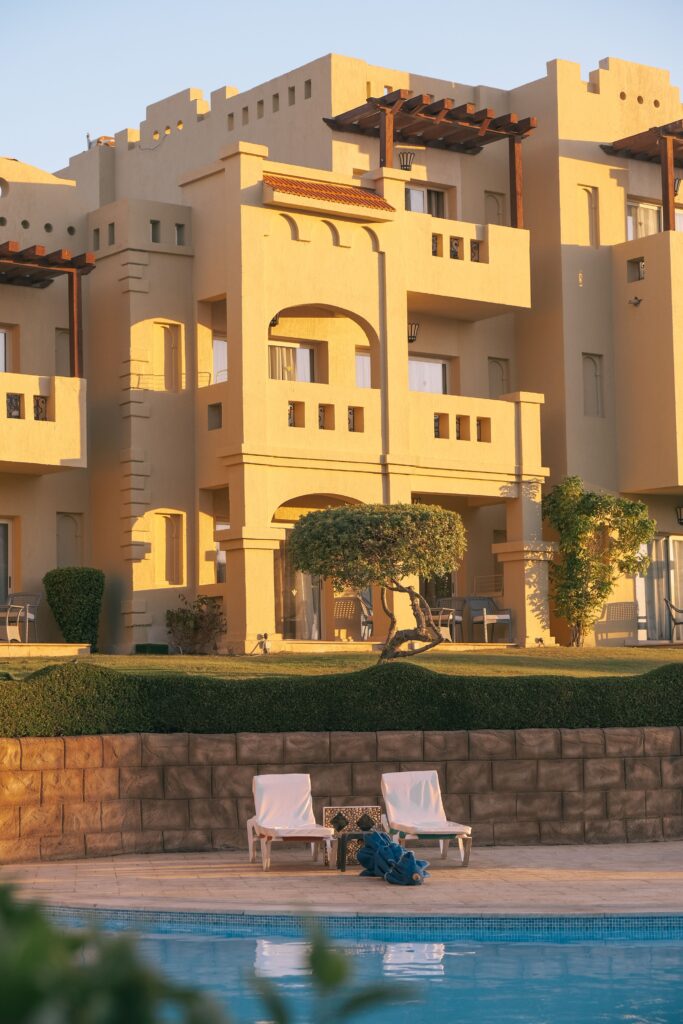 Elegant resort featuring poolside lounge chairs and lush landscaping, perfect for luxury escapes.